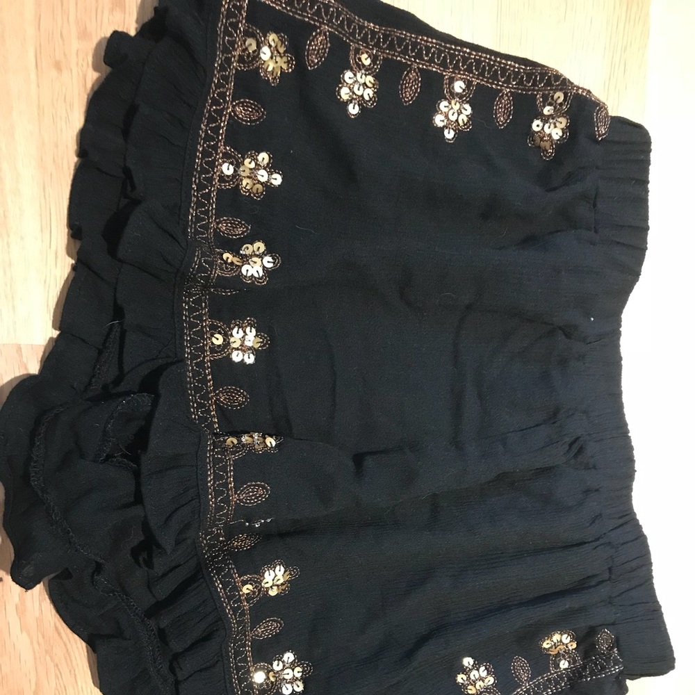 Black ruffle shorts with gold sequins